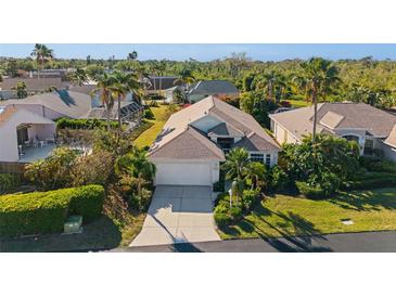 A charming home featuring lush landscaping, mature palm trees, and a well-maintained lawn at 3390 Yonge Ave # 41, Sarasota, FL 34235