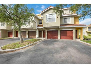 Charming townhomes showcase a tile roof and attached garages, creating an inviting curb appeal at 5691 Bentgrass Dr # 211, Sarasota, FL 34235