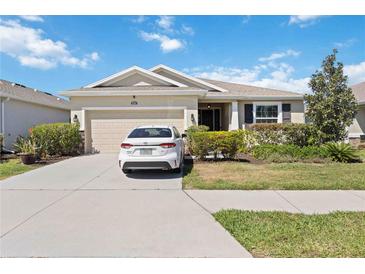 Charming single-story home featuring a well-manicured lawn and attached two-car garage at 6381 Mighty Eagle Way, Sarasota, FL 34241