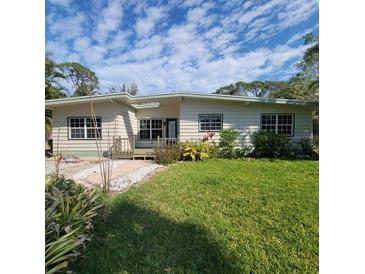 Charming single story home featuring a well-maintained yard with mature landscaping at 835 Indiana Ln, Sarasota, FL 34234