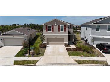 Charming two-story home featuring red shutters, neutral paint, and a spacious two-car garage at 11252 Fieldstone Dr, Palmetto, FL 34221