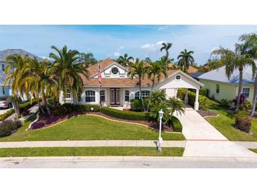 Charming single-Gathering home with a manicured lawn, mature palms, and inviting curb appeal at 4741 Pinnacle Dr, Bradenton, FL 34208