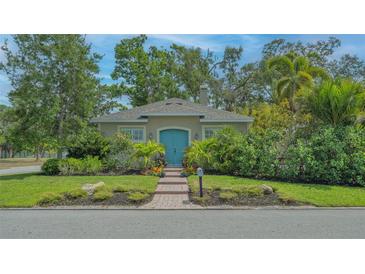 Charming home with blue door, brick path, and lush landscaping at 640 N Osprey Ave, Sarasota, FL 34236