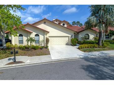 Charming single-Gathering home with a red tile roof, two-car garage and well-maintained landscaping at 7340 Villa D Este Drive, Sarasota, FL 34238