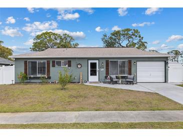 Charming single-story home featuring a well-maintained lawn, inviting front door, and attached garage at 8718 Gaillard Ave, North Port, FL 34287