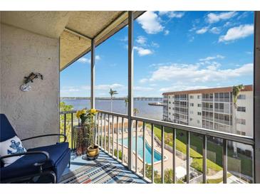 Relaxing screened balcony featuring a serene view of the pool and the scenic water view at 1650 1St W Ave # 503B, Bradenton, FL 34205