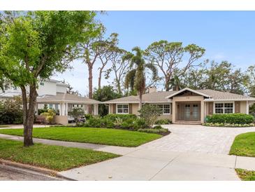 Charming single-story home boasting manicured landscaping, a brick driveway, and a matching carport at 1538 S Orange Ave, Sarasota, FL 34239