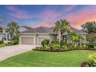 Charming single-story home with a well-manicured lawn, tropical landscaping and a two car garage at 1727 88Th Nw Ct, Bradenton, FL 34209