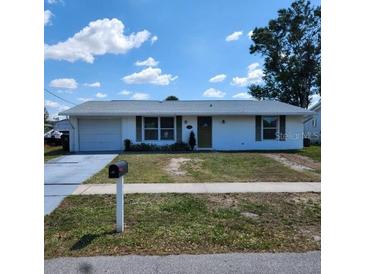 Charming single-story home with a manicured lawn and a classic design at 4070 Grobe St, North Port, FL 34287