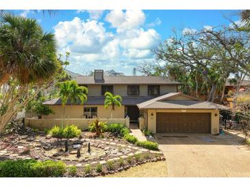 Charming two-story home with well-maintained landscaping, mature trees and two car garage at 4711 Ocean Blvd, Sarasota, FL 34242