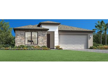 Charming single-story home with a stone facade, two-car garage and lush landscaping at 5877 Freestone Cir, Apollo Beach, FL 33572