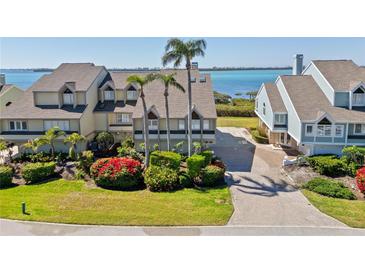 Waterfront townhome features lush landscaping, brick paver driveway, and stunning ocean views in a desirable coastal community at 71 Tidy Island Blvd, Bradenton, FL 34210