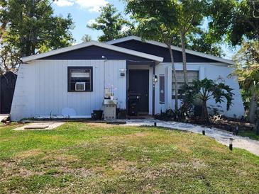 Charming single story home with a landscaped front yard and walkway leading to the front door at 1854 Debbie St, Sarasota, FL 34231