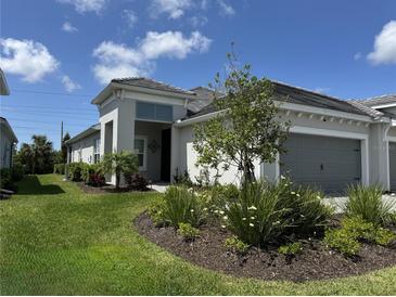 Charming single-story home with well-manicured lawn and flower beds at 2918 Butterfly Jasmine Trl, Sarasota, FL 34240