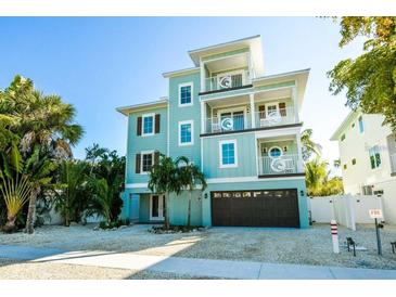 Beautiful three-story coastal home with multiple balconies and a convenient ground-level garage at 336 Avenida De Mayo, Sarasota, FL 34242