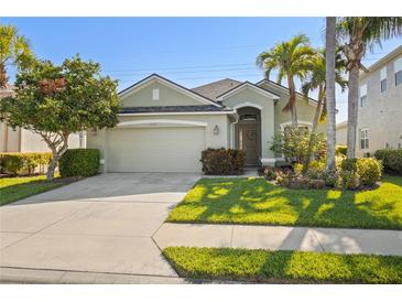 Charming single-story home features a well-maintained lawn, mature landscaping, and an attached two-car garage at 3752 Summerwind Cir, Bradenton, FL 34209