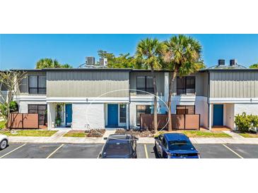 Charming townhouse with a blue front door and beautiful landscaping and private fenced in patios at 4001 Beneva Rd # 343, Sarasota, FL 34233