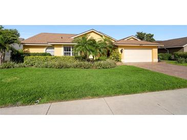 Charming single-story home boasts lush landscaping, mature palms, and a well-maintained lawn at 4622 Meadowview Cir, Sarasota, FL 34233