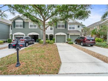 Charming townhome featuring well-maintained landscaping, a two-car garage, and a welcoming entrance at 7180 83Rd E Dr # 6-5, Bradenton, FL 34201