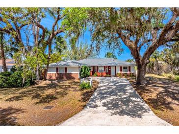Charming single-story home featuring a long driveway and mature trees in a desirable neighborhood at 7299 S Leewynn Dr, Sarasota, FL 34240