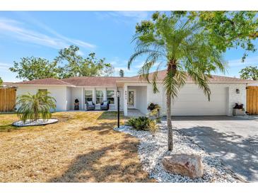 Charming single-story home with well-manicured landscaping and a welcoming front porch, with a two car garage at 8419 Sylvan Woods Dr, Sarasota, FL 34243