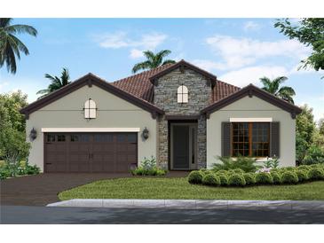 Charming single-story home with stone accents, a tile roof, a two-car garage, and a landscaped front yard at 11008 Hogan Cir, Englewood, FL 34223