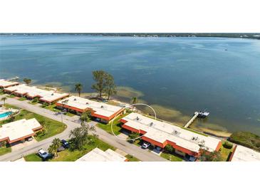 Scenic aerial view of waterfront condos with private dock access and lush landscaping along the Tampa Bay at 3859 Catalina Dr, Bradenton, FL 34210