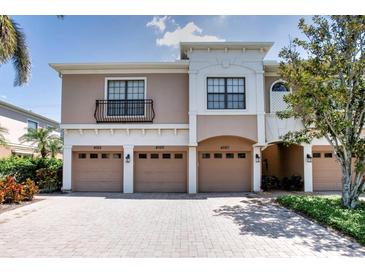 Charming townhome showcasing multiple garages, beautiful brick driveway and manicured landscaping at 4069 Overture Cir # 341, Bradenton, FL 34209