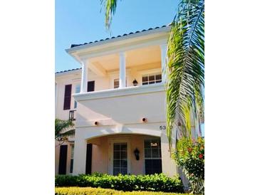 Charming two-story townhome featuring a balcony and lush landscaping at 5360 Davini St, Sarasota, FL 34238