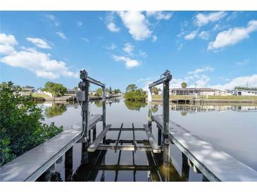 Beautiful waterfront view from private dock with boat lift and serene canal at 108 Martin Ne Dr, Port Charlotte, FL 33952