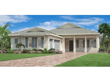 Charming one-story home features a symmetrical design, manicured lawn, and a paver driveway at 17916 Palmiste Dr, Bradenton, FL 34202