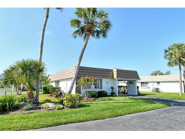 Charming single-story home with tropical landscaping and a covered carport area at 2752 Riverbluff Pl # 66, Sarasota, FL 34231