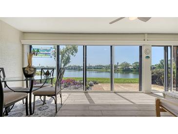 Bright dining area with waterfront views through sliding glass doors, allowing abundant natural light to fill the space at 515 Spring Lakes Blvd # 515, Bradenton, FL 34210