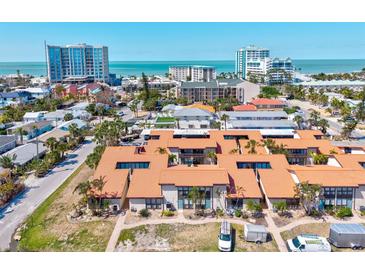 Beautiful aerial view of condo community near beach with turquoise water and city buildings on the horizon at 800 S Blvd Of The Presidents # 3, Sarasota, FL 34236