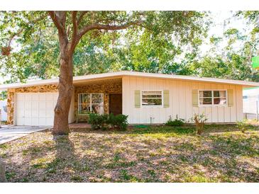 Charming single-story home with stone accents and a well-maintained front yard at 2110 Euclid Ter, Sarasota, FL 34239