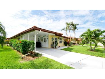 Charming single-story home featuring a covered carport, lush landscaping, and a welcoming front entrance with coastal accents at 3112 Cambridge Ave # 6, Bradenton, FL 34207