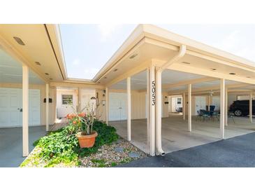 Charming carport welcomes you to this well-maintained condo with lush landscaping at 5053 Live Oak Cir, Bradenton, FL 34207