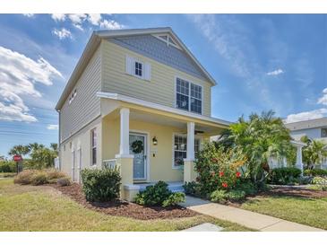 Charming two-story home with a welcoming front porch, lush landscaping, and a well-maintained lawn at 5532 River Sound Ter, Bradenton, FL 34208