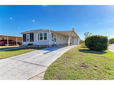 Charming single-story home with a long driveway and well-maintained landscaping at 5619 Bayshore Rd # 152, Palmetto, FL 34221
