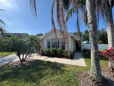 Charming single-story home with lush tropical landscaping and well-maintained lawn at 11811 53Rd Ct E, Parrish, FL 34219