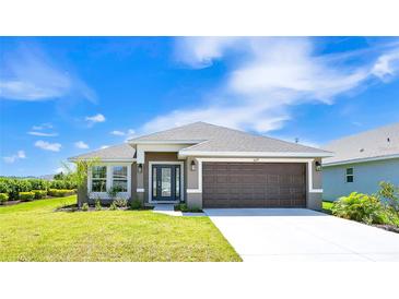 Charming single-story home with a well-manicured lawn, a two-car garage, and inviting curb appeal at 16139 69Th E Ln, Parrish, FL 34219