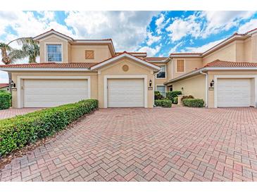 This townhouse has three garage spaces and brick driveway at 23261 Banbury Way # 501, Venice, FL 34293