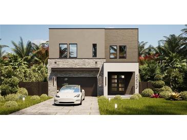 Contemporary two-story home with a stone facade, attached garage and modern landscaping at 3847 30Th S Ave, St Petersburg, FL 33711