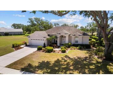 Charming single-story home with well-manicured landscaping, inviting curb appeal, and an attached two-car garage at 3859 Little Country Rd, Parrish, FL 34219