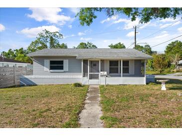 Charming single-story home featuring a screened porch and inviting walkway at 5001 15Th N Ave, St Petersburg, FL 33710