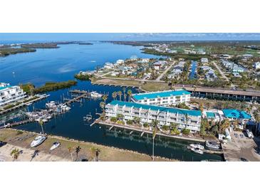 Scenic aerial view of waterfront condos and boat docks along the water at 8222 Harborside Cir, Englewood, FL 34224
