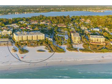 Stunning aerial view of a beachfront resort with lush landscaping and ocean views at 915 Seaside Dr # 606 Weeks 6-7, Sarasota, FL 34242