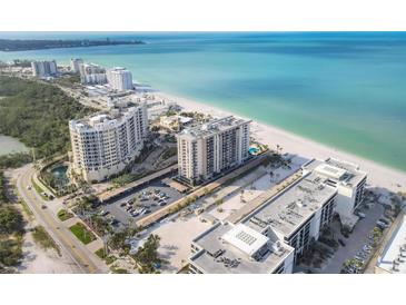 Stunning aerial view of the beach condos and turquoise ocean waters at 1212 Benjamin Franklin Dr # 708, Sarasota, FL 34236