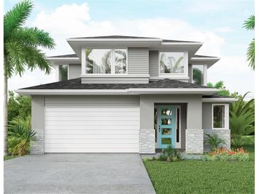 Modern two-story home featuring gray siding, stone accents, a two-car garage, and a bright blue front door at 2563 Loma Linda St, Sarasota, FL 34239