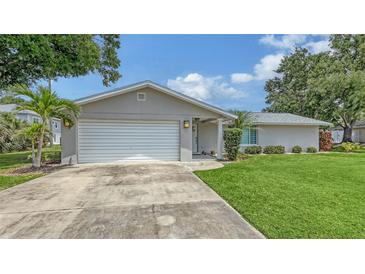 Charming single-story home featuring an attached garage, well-maintained lawn, and freshly painted exterior at 755 Taplow Rd, Venice, FL 34293